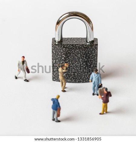 The concept of a collective solution to any problem. Miniature toy workers and security key using as background security system, hack, business concept. 