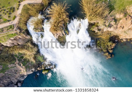 Waterfall Duden (Düden) into the Mediterranean sea.  Waterfall falling into sea. Waterfall stream. Aerial drone shooting. ANTALYA