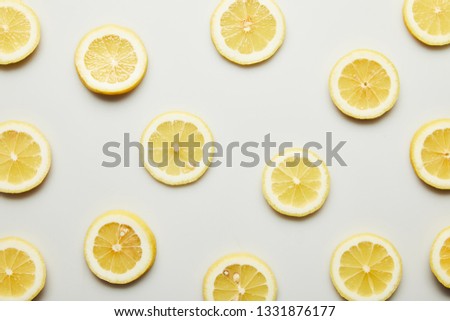 Top view of juicy lemon slices on grey background