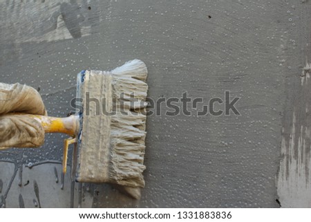 Coat the concrete wall with a cement polymer waterproofing membrane Royalty-Free Stock Photo #1331883836