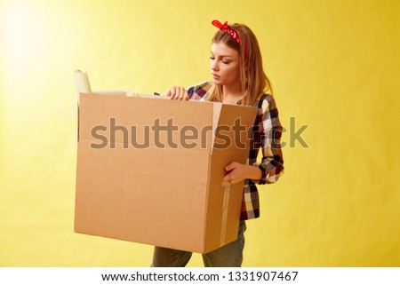 People moving new place and repair concept - Young woman holding cardboard box.