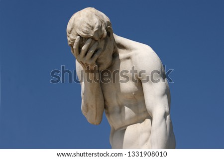 Facepalm - a statue with its head in its hand Royalty-Free Stock Photo #1331908010