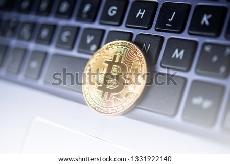 Golden Bitcoin new internet virtual money on a keyboard of laptop. 