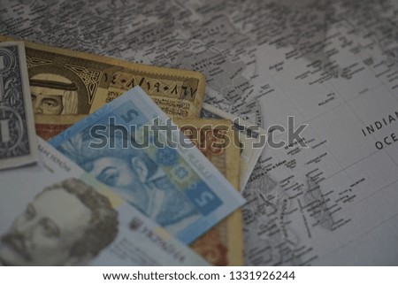 Money on the map. Travel concept. Image maybe sightly blur, noise or grain.