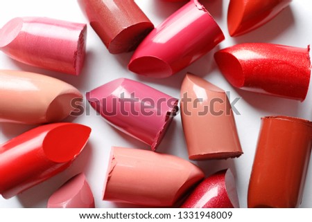 Collection of lipsticks on white background, top view