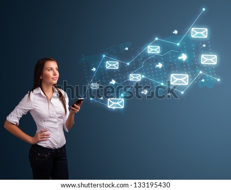 Attractive young lady standing and holding a phone with arrows and message icons