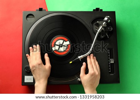 Female DJ mixing music on color background Royalty-Free Stock Photo #1331958203