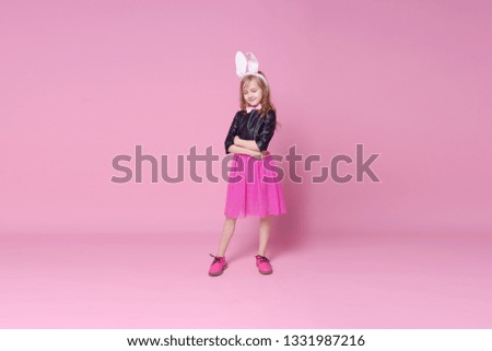 Funny baby girl in the form of Easter Bunny. Concept of holidays, beauty and fashion. Selective focus.