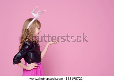 Cute baby girl in the form of a rabbit for advertising. Palms are folded for advertising. Concept of advertising and lifestyle. Black Friday and sale.