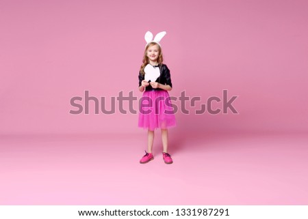 Funny girl in the shape of an Easter Bunny with a layout of a human tooth. Concept of medicine. Day of the stomatologist. Selective focus.