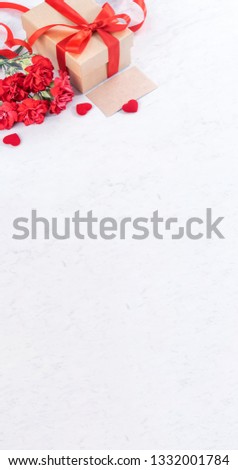 May mothers day concept handmade giftbox idea wishes photography - Beautiful blooming carnations with red ribbon bow box isolated on modern marble desk, close up, copy space, mock up
