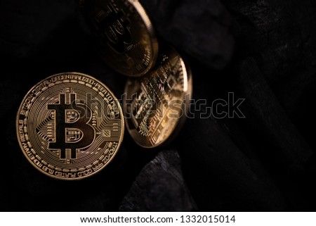 Bitcoin mining concept. Bitcoin cuurency on charcoal. Close up details