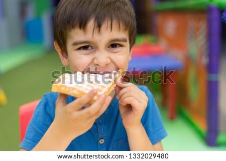 boy eating waffle with sugar