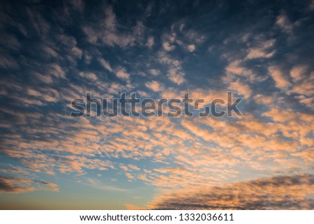 Bright sunset sky. Orange cirrocumulus clouds.