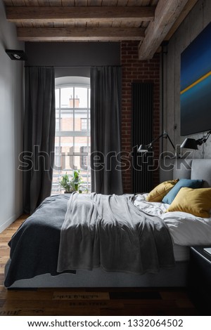 Industrial style bedroom with modern painting and gray window curtains