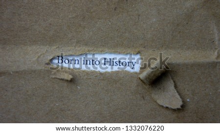 Torn paper with text born into history
