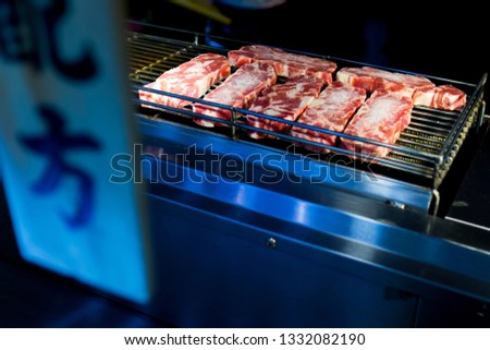 Beef Steak Cooking on Bbq Grill Oven. Street Food Vendor In Taiwan.Taiwanese word in picture are "Match formula"