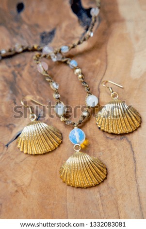 Jewelry set with earrings and necklace in shell shape, blur
