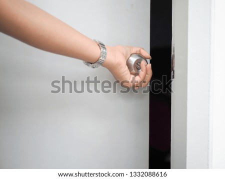 Hand closing the gray door