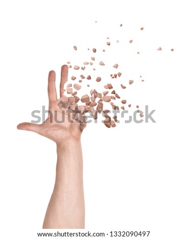 Close-up of man's hand with fingers and palm starting to dissolve into pieces isolated on white background. Psychological problems. Health risks. Go through transformation.