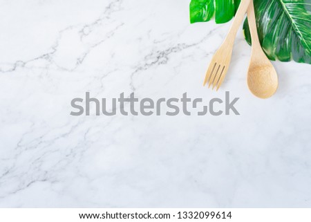 Bamboo wood toothbrush on clean white marble table top view background concept for save the earth day, world environmental, plastic free, kitchen flat lay lifestyle, bathroom reusable wood product.