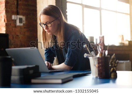A girl works at a computer in a modern office