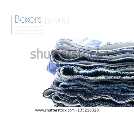 Travel/moving concept stock image. Freshly laundered men's/youth's boxer shorts stacked against a white background. Copy space.