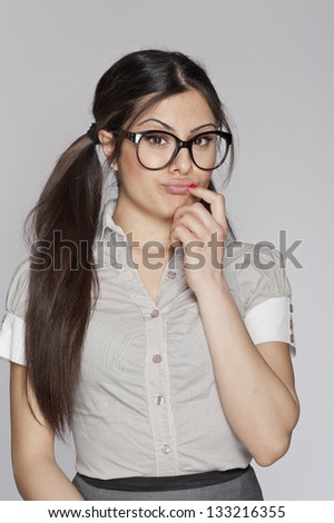 Young unsure nerd woman thinking on white background