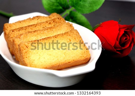 Rusk in the plate with red rose Royalty-Free Stock Photo #1332164393
