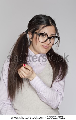 Young nerd woman posing on white background
