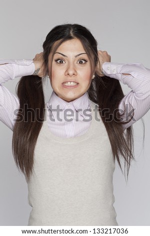 Young nerd woman crazy expression posing on white background