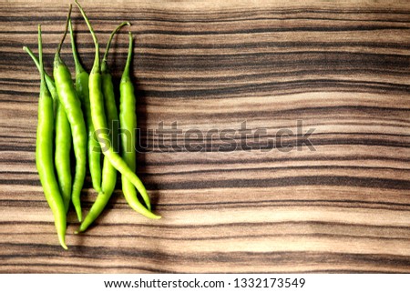 Green chilies on the texture Royalty-Free Stock Photo #1332173549