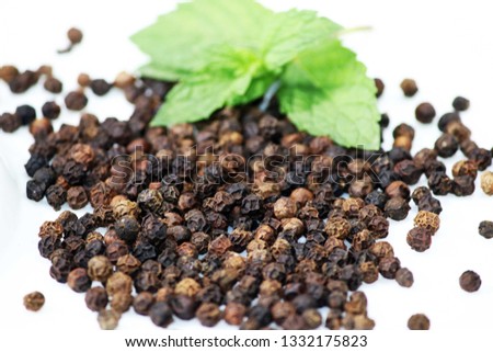 Black Pepper Seeds with green leaves Royalty-Free Stock Photo #1332175823