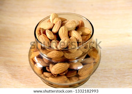Almonds in the bowl Royalty-Free Stock Photo #1332182993