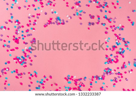 Festive party holiday colorful confetti on pink background  with copy space. 