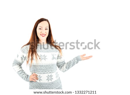 Happy young woman smiling while doing a hand gesture to one side against a white background