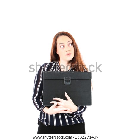 Curious young business woman looking up while holding a work case against a white background