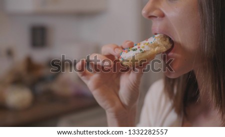 Young woman eats sweet sugar doughnuts