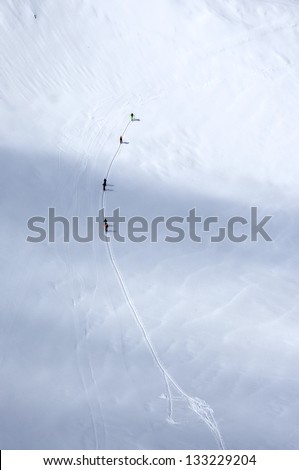 A group of skiers wandering across a glacier in Austrian Alps