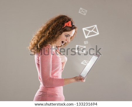 Beautiful young girl with tablet is using social media