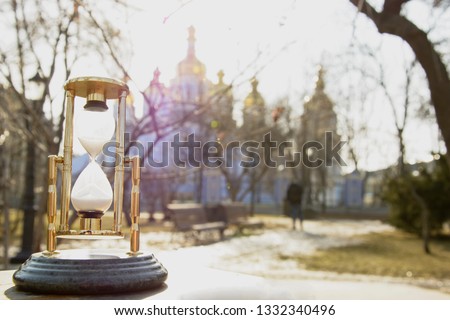 Hourglass, time, orthodoxy, church, temple, religion, God, God Jesus, walk, tourism, life, sadness, longing, sadness, faith in God, sunny day, park, city, street, trees, panorama of the church