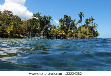 Boat anchored near a tropical island with lush vegetation, Caribbean, Panama