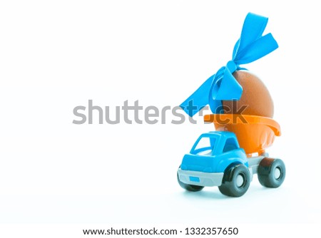 Easter egg and toy car - truck on white background, happy easter day concept, space for text