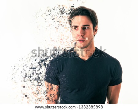 Side view of handsome serious man in effect of diffusion with fragments flying away on white background