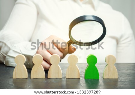 Businesswoman searching for new employees. Staff recruitment. Select a person in the team. Find a talented employee. Attracting people to work. Human Resource Management. Recruiting. Magnifying glass