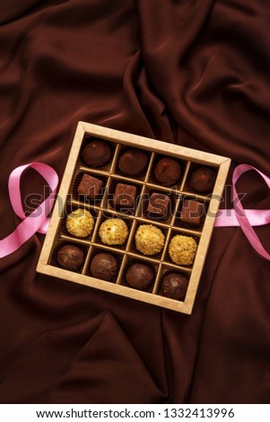 Handmade chocolate truffles box on brown silk background