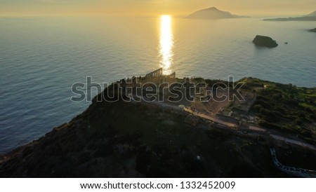 Aerial drone photo of archaeological site of Cape Sounio with iconic ruins of Temple of Poseidon at sunset, Attica, Greece
