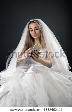 bride with cellphone. bride make selfie on a mobile phone.