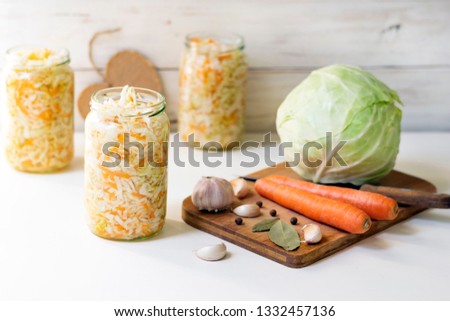 Cooking sauerkraut, jar of sauerkraut and ingredients for its preparation