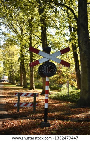 St. Andrew's Cross sign for railway crossing, in the city park.
